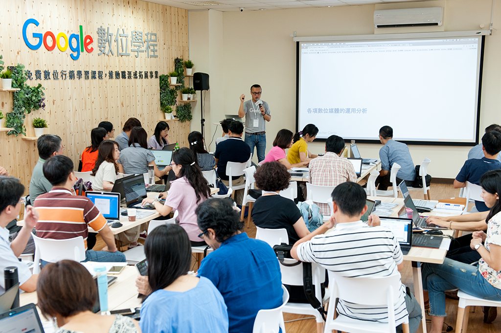 A Google digital course classroom, participants working on laptops