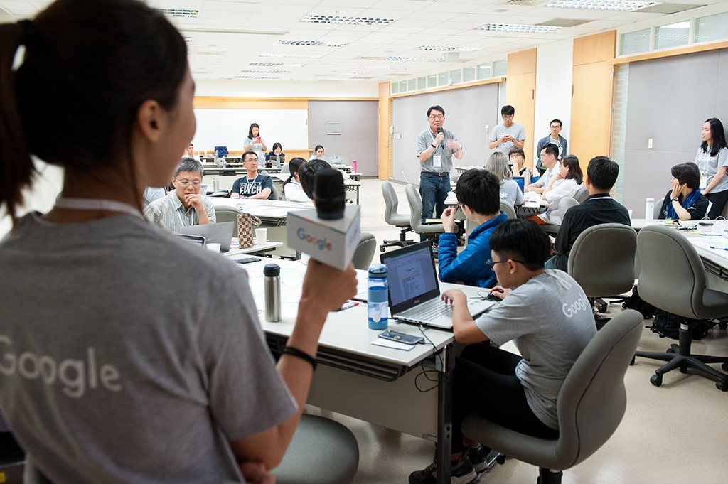 A Google instructor working with participants in a small classroom