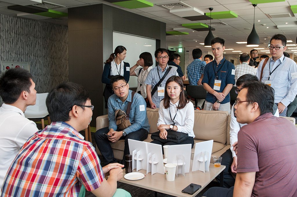 Attendees chatting in an office lounge