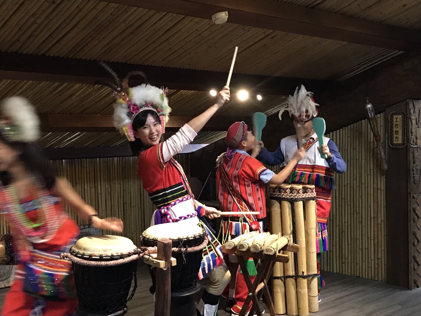 Indigenous performers drumming and dancing during filming