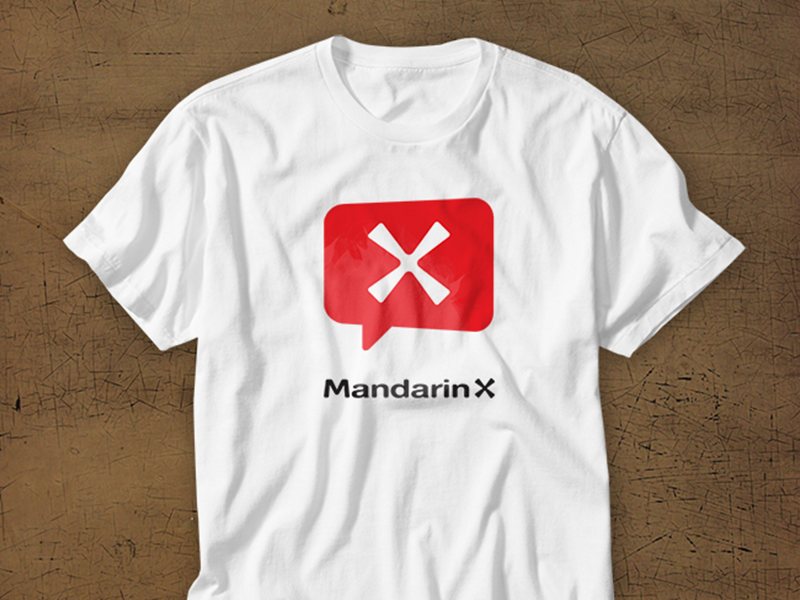 A white T-shirt printed with the MandarinX mark