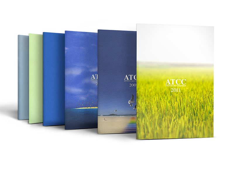 Commemorative ATCC books from successive years, fanned out